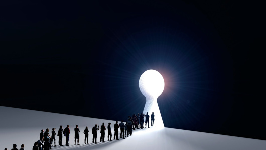 People in front of a bright keyhole opening