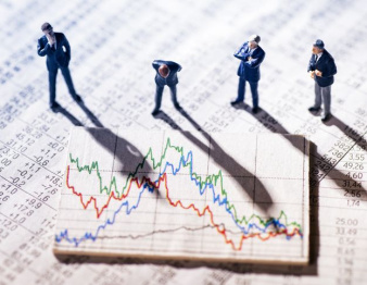 Businessmen looking at market charts